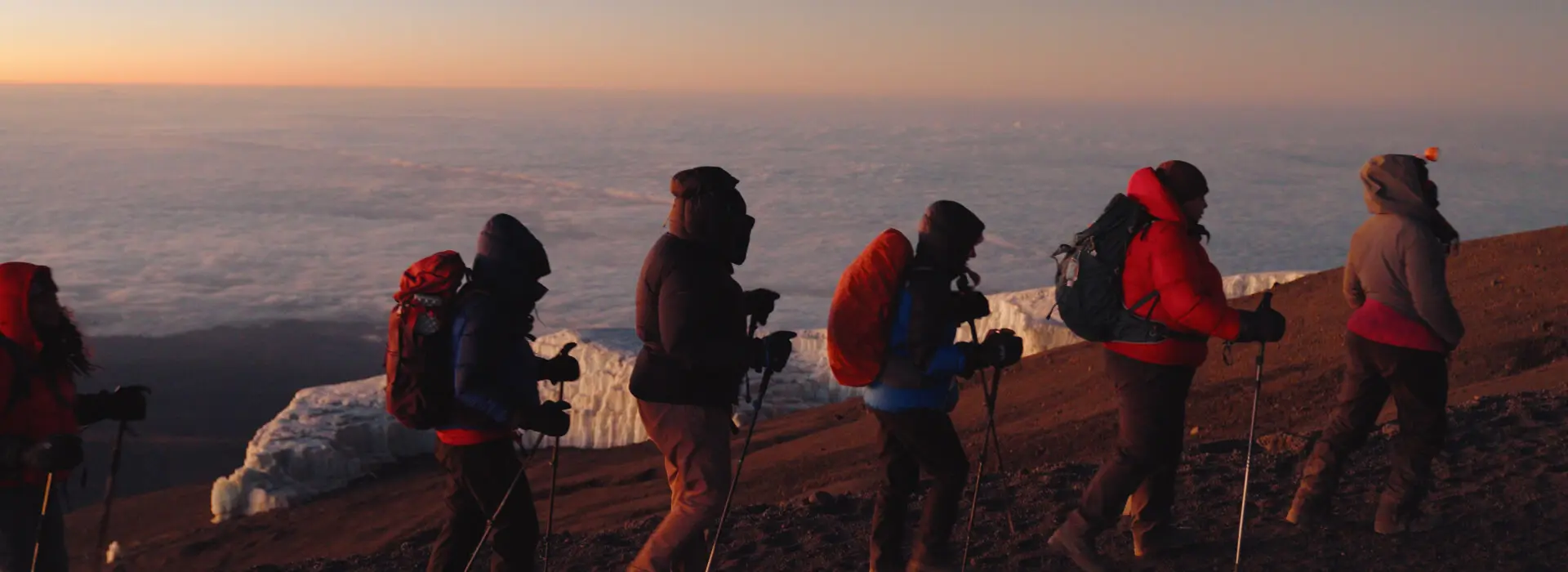 Trekkers heading for the summit of Mt. Kilimanjaro (Uhuru Peak) as the sun begins to rise