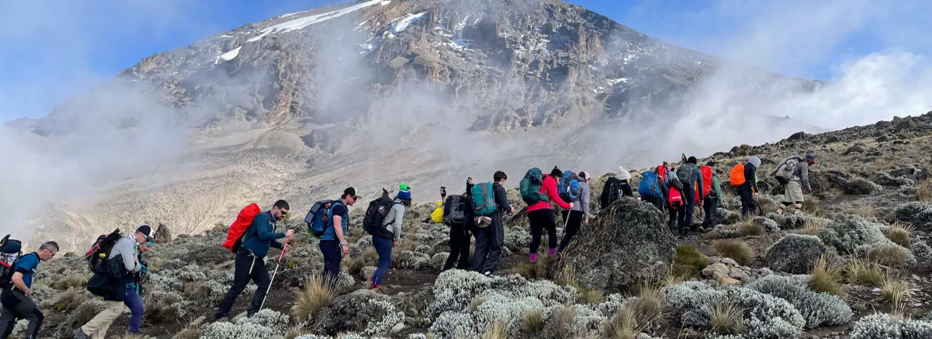 A single line of trekkers climbing mount Kilimanjaro