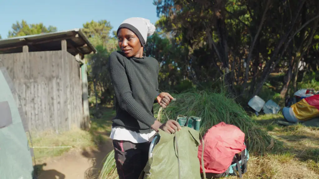 A Kilimanjaro porter wearing clothing from our porter clothing drive initiative