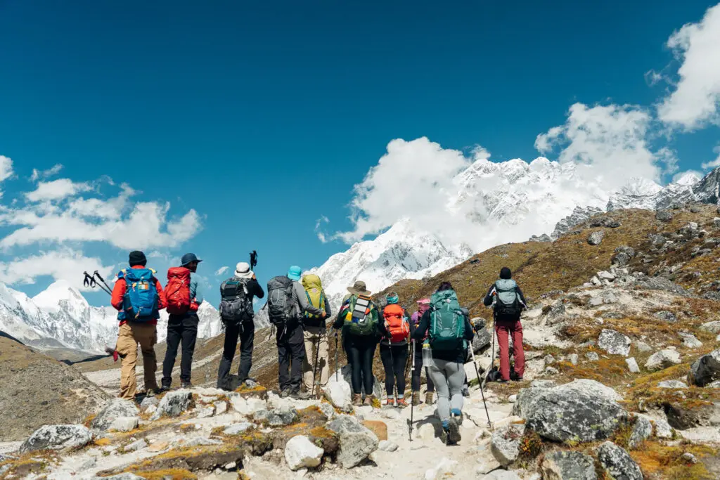 Hikers soaking in panoramic Himalayan mountain views on the Everest Base Camp expedition with Earth’s Edge.