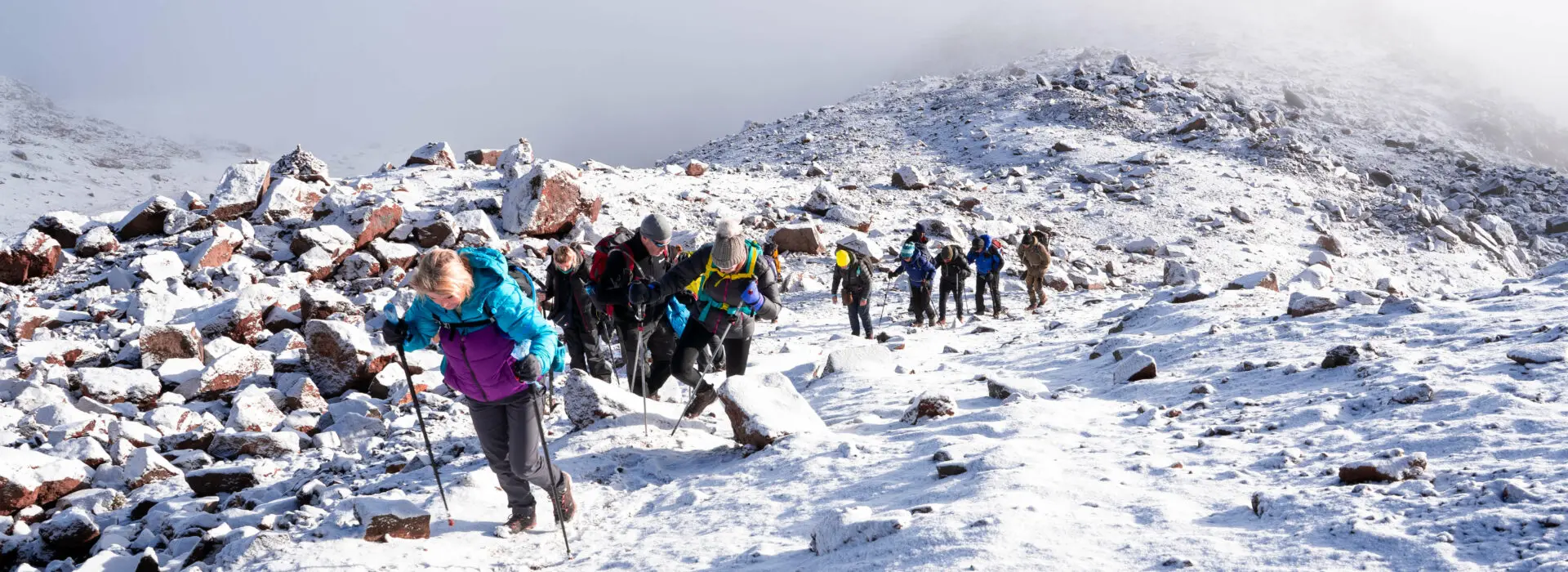 A group of trekkers climbing in the snow to the Lenana Peak, Mt. Kenya