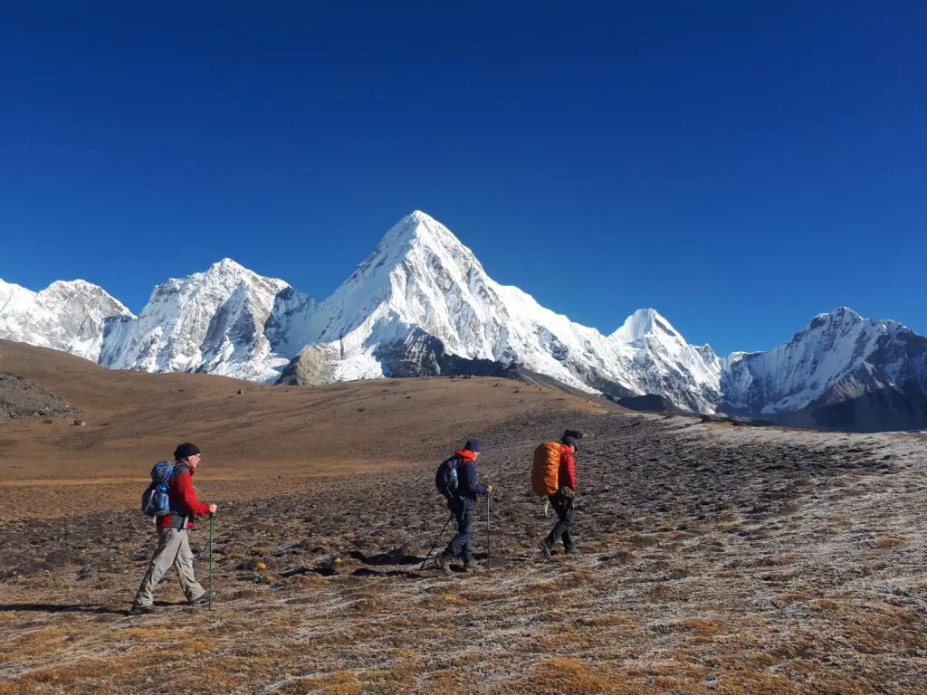 Three hikers trekking at high altitude which can cause altitude-related illnesses