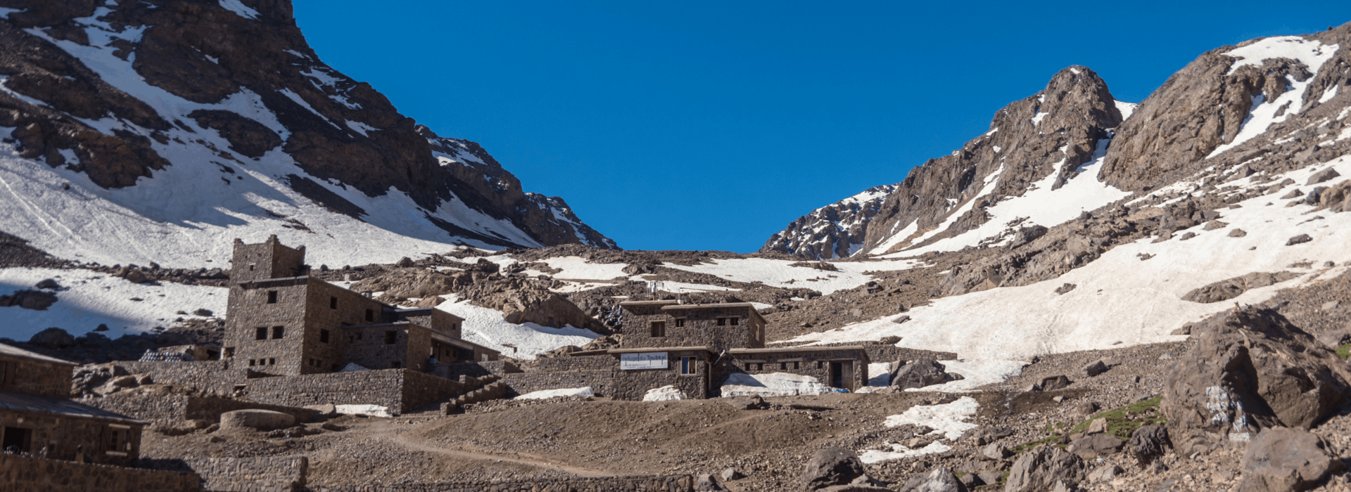 High-altitude refuge at Jebel Toubkal base camp surrounded by rocky Atlas Mountains
