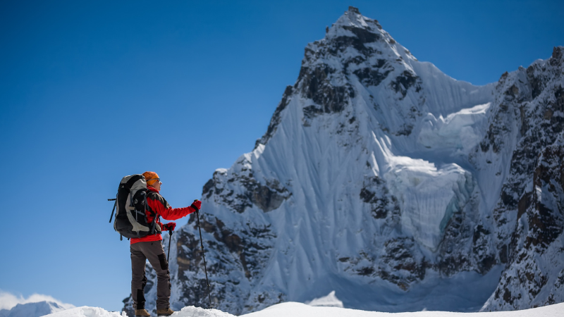 A hiker in the snow at Renjo La Pass in Nepal