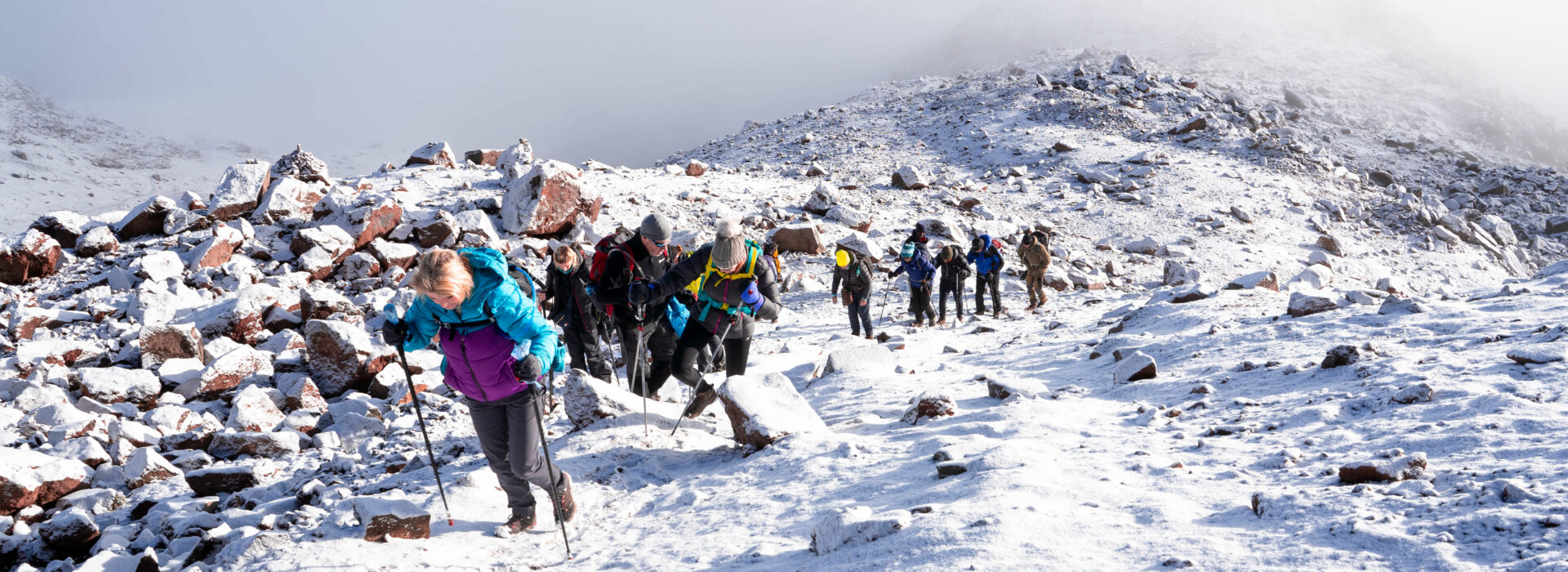 A group of trekkers climbing in the snow to the Lenana Peak, Mt. Kenya
