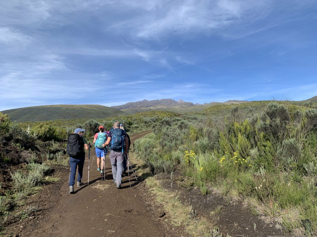 Trekking group on the trail to Mount Kenya after receiving medical safety briefing from expedition doctor