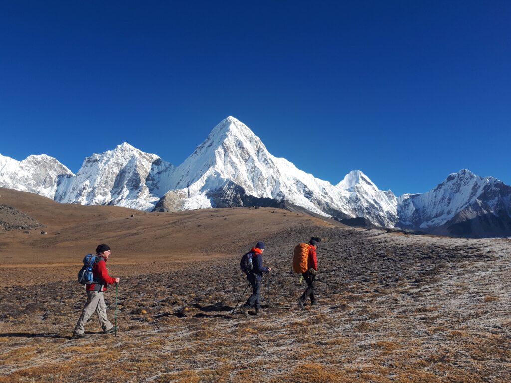 Three hikers trekking at high altitude which can cause altitude-related illnesses