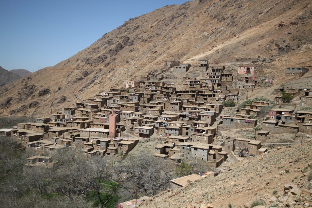 A Berber village built into the side of a mountain, on the Toubkal Circuit, High Atlas Mountains, Morocco