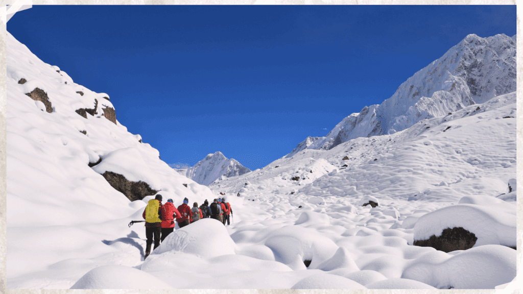 Trekkers hiking through deep snow in Gorakshep, Nepal